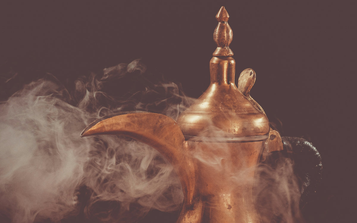 Traditional brass dallah Arabic coffee pot with steam