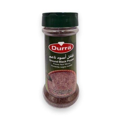 Durra Spices ground black pepper in clear plastic shaker with green lid, coarse texture visible through label