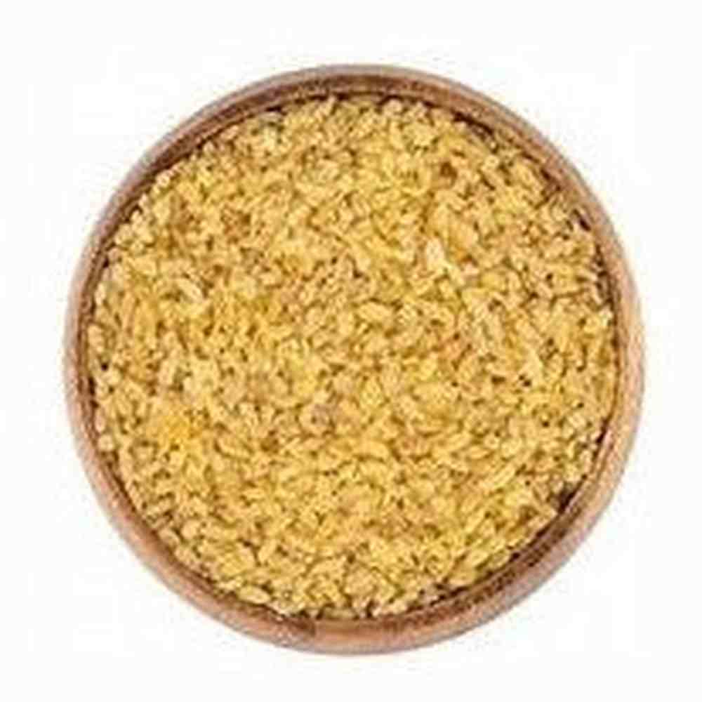 Close-up of golden-yellow finely cracked bulgur texture in wooden bowl