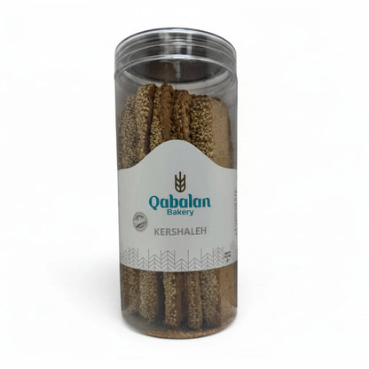 Qabalan Sesame Tea Rusk sticks densely coated in light tan seeds inside jar with 100% Natural seal